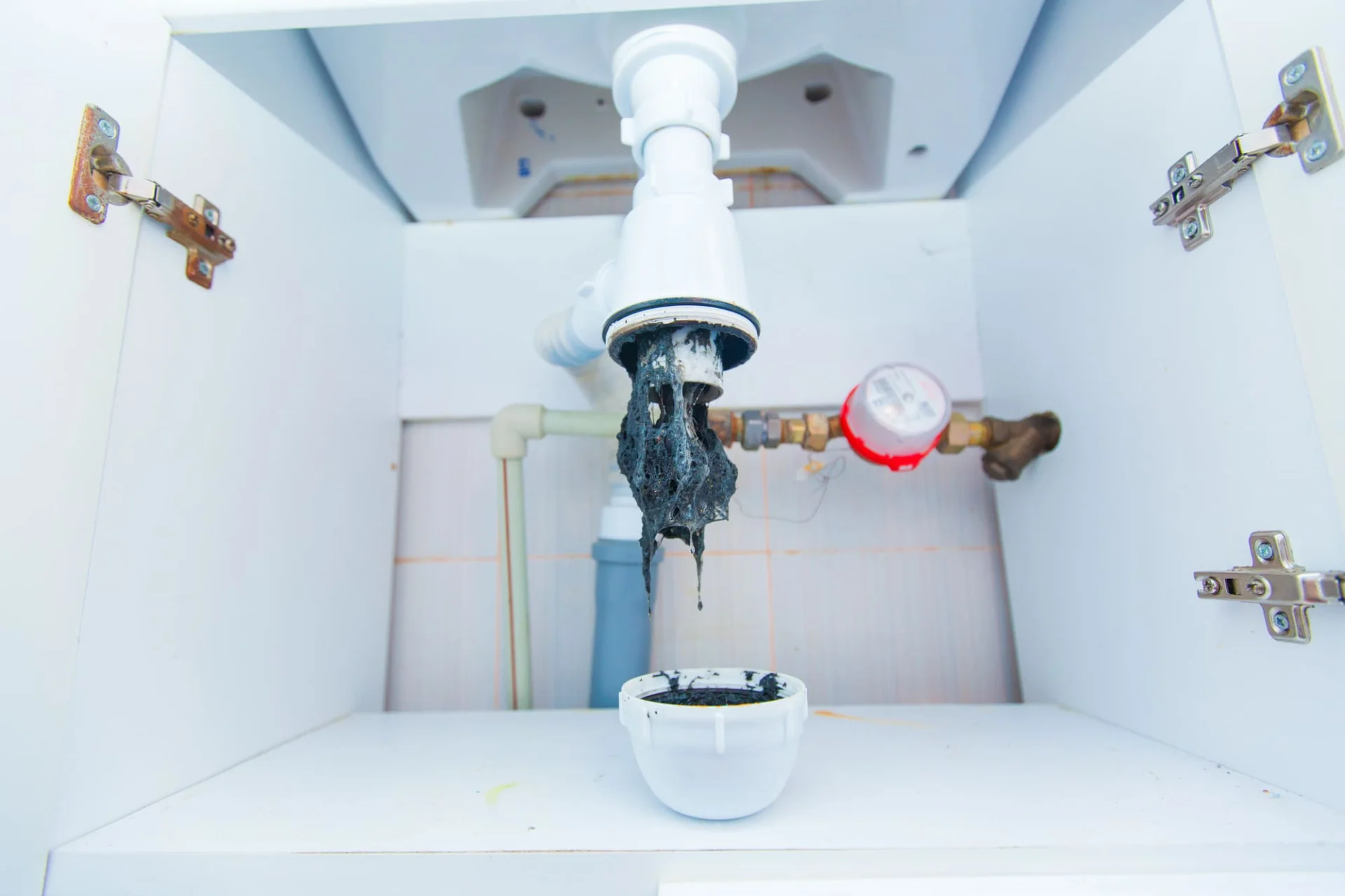 Plumber handling drain cleaning service in Grimsby home